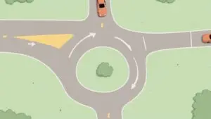 Modern single-lane roundabout on a sunny day with clear traffic markings and landscaping