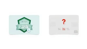 Woman smiling while looking at a laptop and holding a credit card, ready to enroll in an online course.