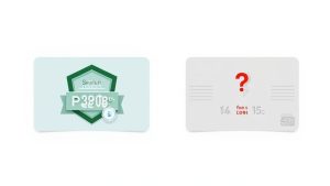 Woman smiling while looking at a laptop and holding a credit card, ready to enroll in an online course.