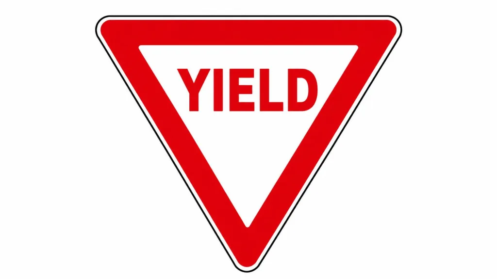 A standard red and white inverted triangle shaped yield traffic sign on a plain white background.