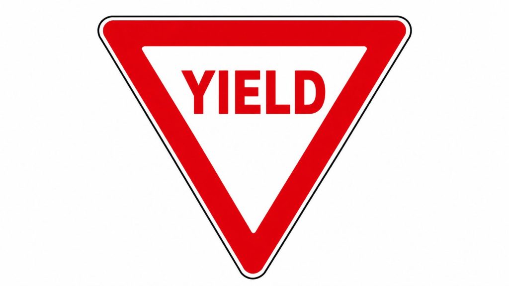 A standard red and white inverted triangle shaped yield traffic sign on a plain white background.